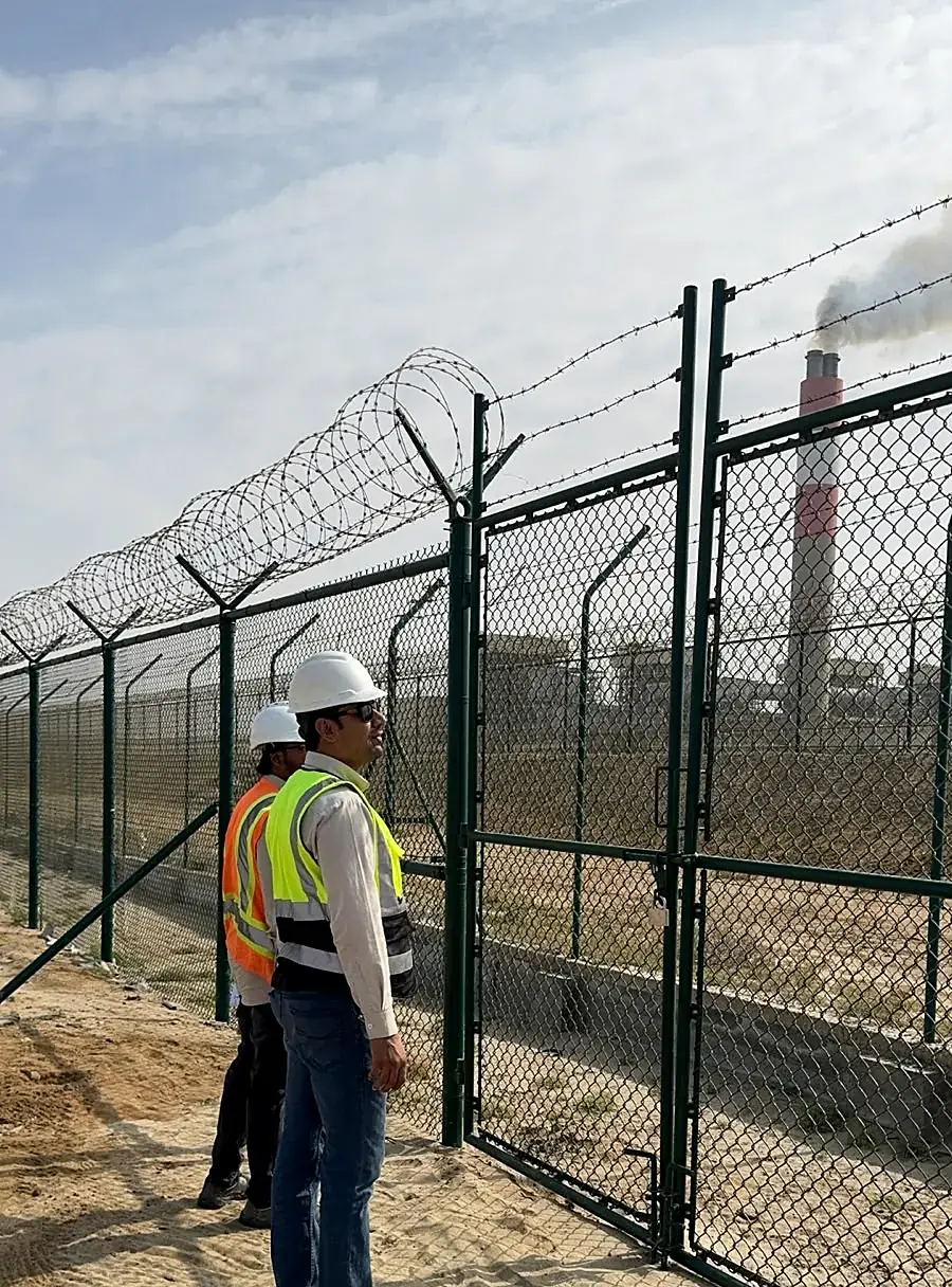 Engineers inspecting a completed HCIS security fence