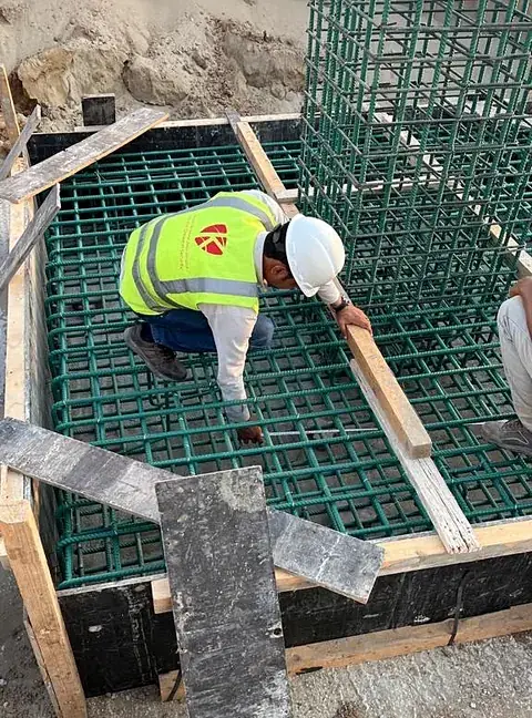 Steel fixer tying footing reinforcement